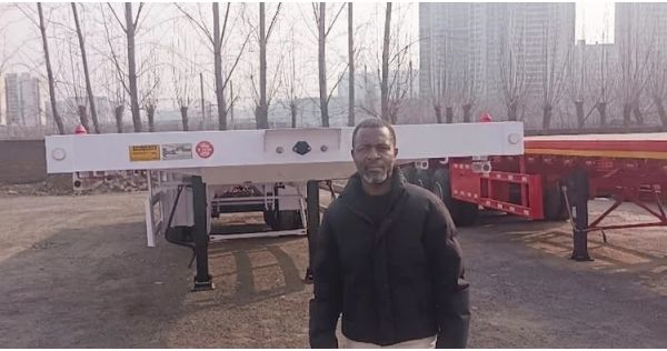 Un cliente de Sierra Leona visita TITAN para comprar un remolque de plataforma.